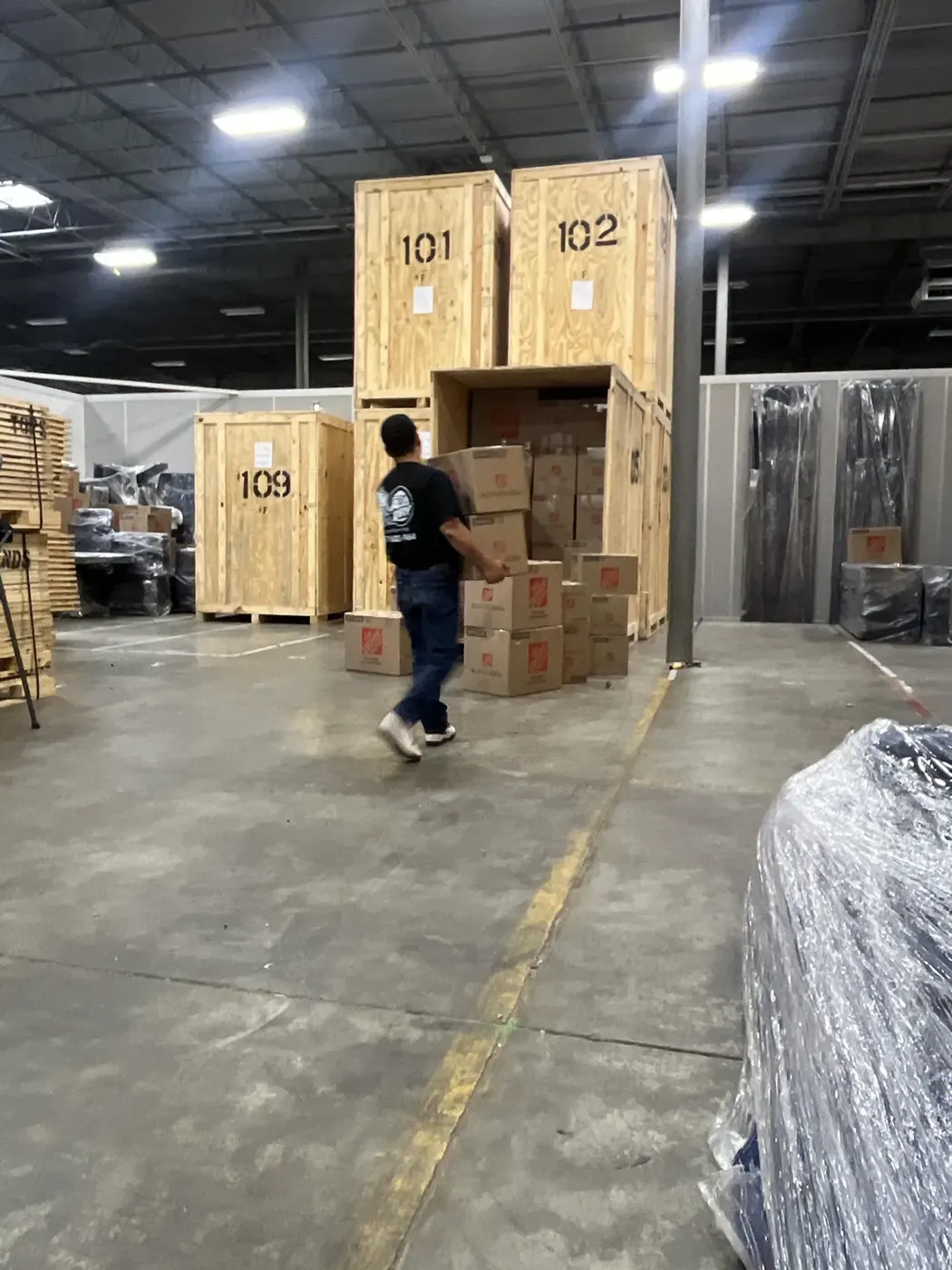 All Dry crew member loading a customerβs belongings into a numbered storage vault