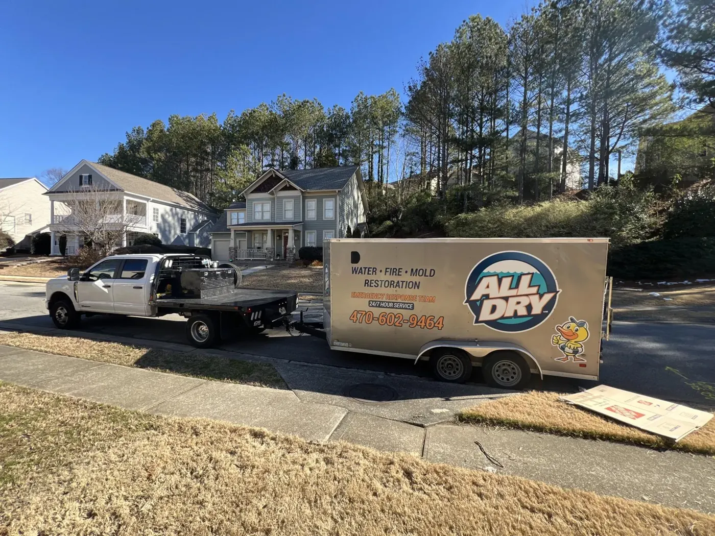 All Dry Services truck and equipment trailer parked at a metro Atlanta job