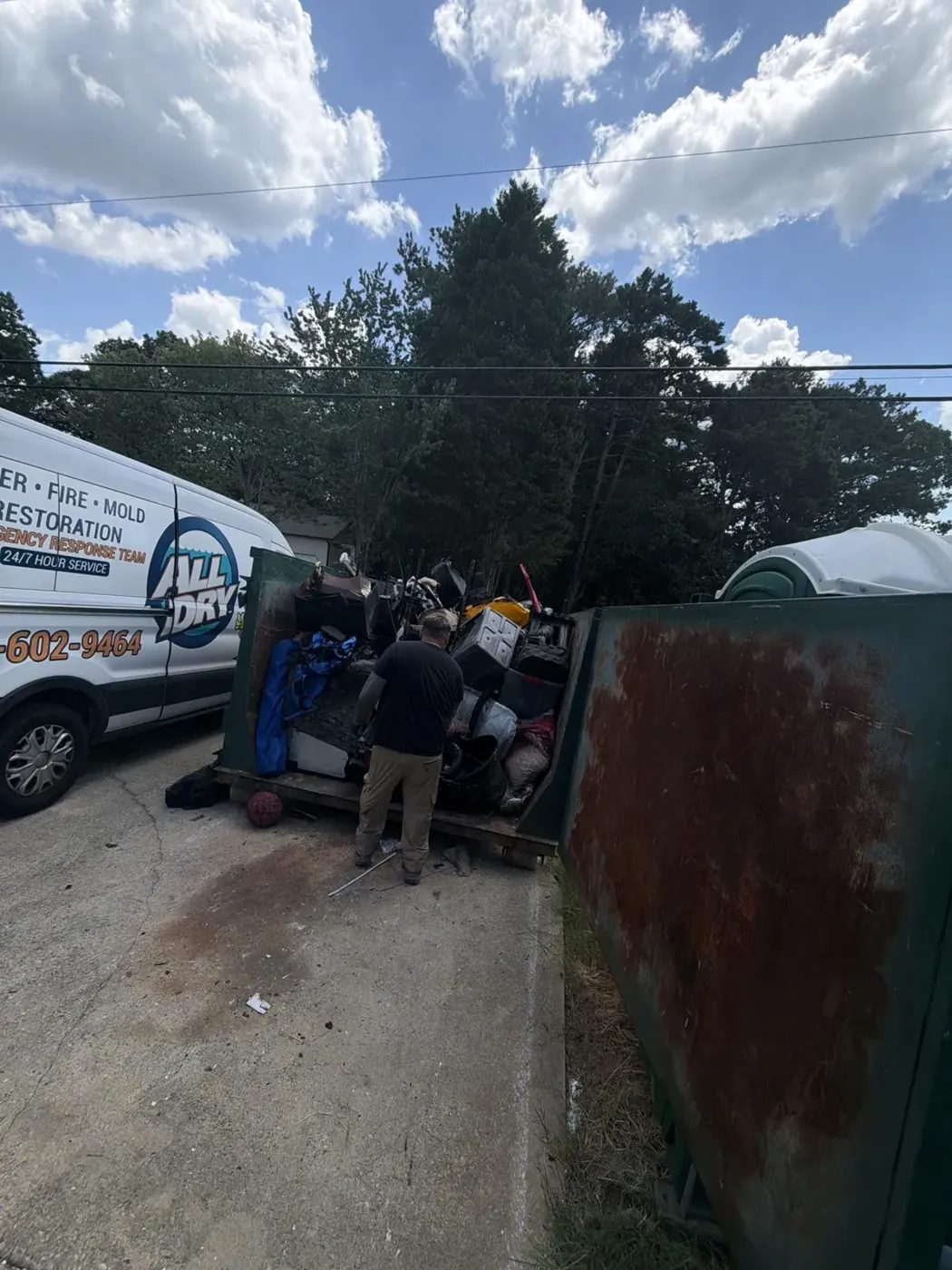 All Dry crew removing fire debris into a dumpster in Dacula, GA