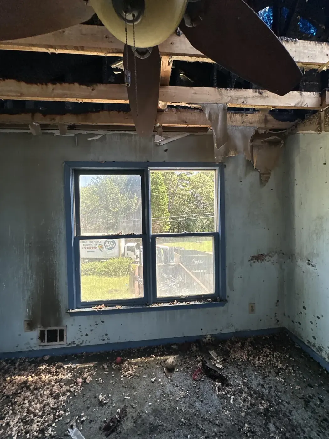 Fire-damaged bedroom with charred walls and ceiling in Dacula, GA