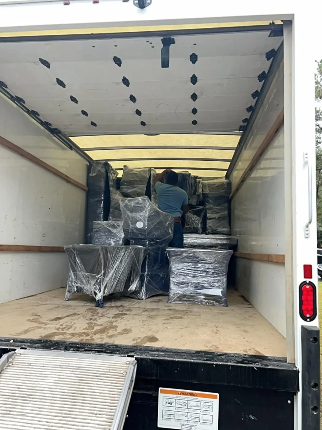 Shrink-wrapped furniture loaded in a truck for safe storage